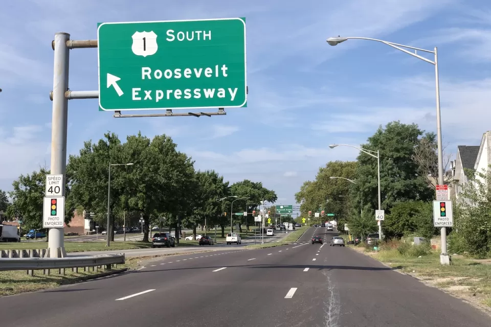 View of three-lane Roosevelt Boulevard with green Roosevelt Expressway road sign in Philadelphia, Pennsylvania.